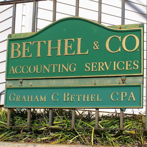 Green business sign on a metal fence that reads 'BETHEL & CO. ACCOUNTING SERVICES' with a bottom panel 'GRAHAM C BETHEL CPA' indicating an accounting firm. - Clayton, GA