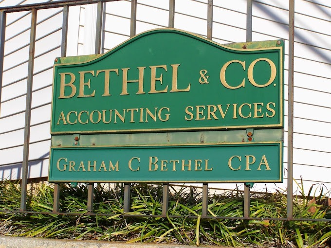 Bethel & Co LLC Green business sign on a metal fence that reads 'BETHEL & CO. ACCOUNTING SERVICES' with a bottom panel 'GRAHAM C BETHEL CPA' indicating an accounting firm. - Clayton, GA