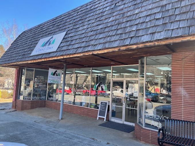 Clayton Claws & Paws Front of a pet supply store with brick exterior, large glass windows, and a sloped shingled roof; sign reads Claws & Paws. - Clayton, GA