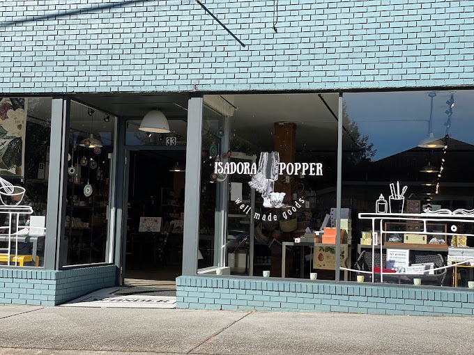 Isadora Popper - Visit Clayton, GA Storefront for Isadora Popper, a handmade goods shop, with large glass windows and visible merchandise inside. - Clayton, GA