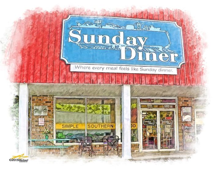 Front view of Sunday Diner storefront with a red awning, blue sign reading 'Sunday Diner' and outdoor seating outside the windows. Tagline: 'Where every meal feels like Sunday dinner.' - Clayton, GA