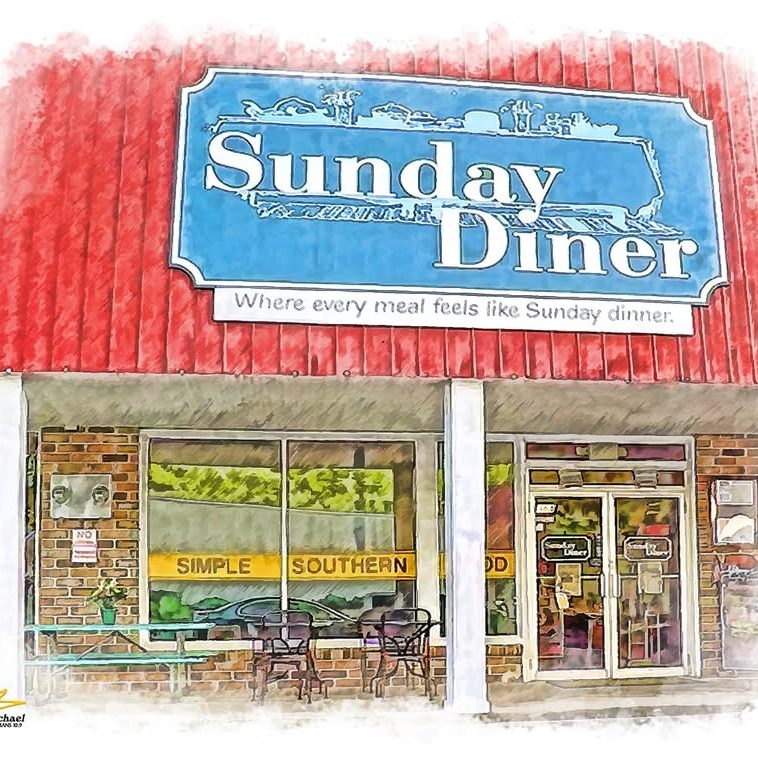 Front view of Sunday Diner storefront with a red awning, blue sign reading 'Sunday Diner' and outdoor seating outside the windows. Tagline: 'Where every meal feels like Sunday dinner.' - Clayton, GA