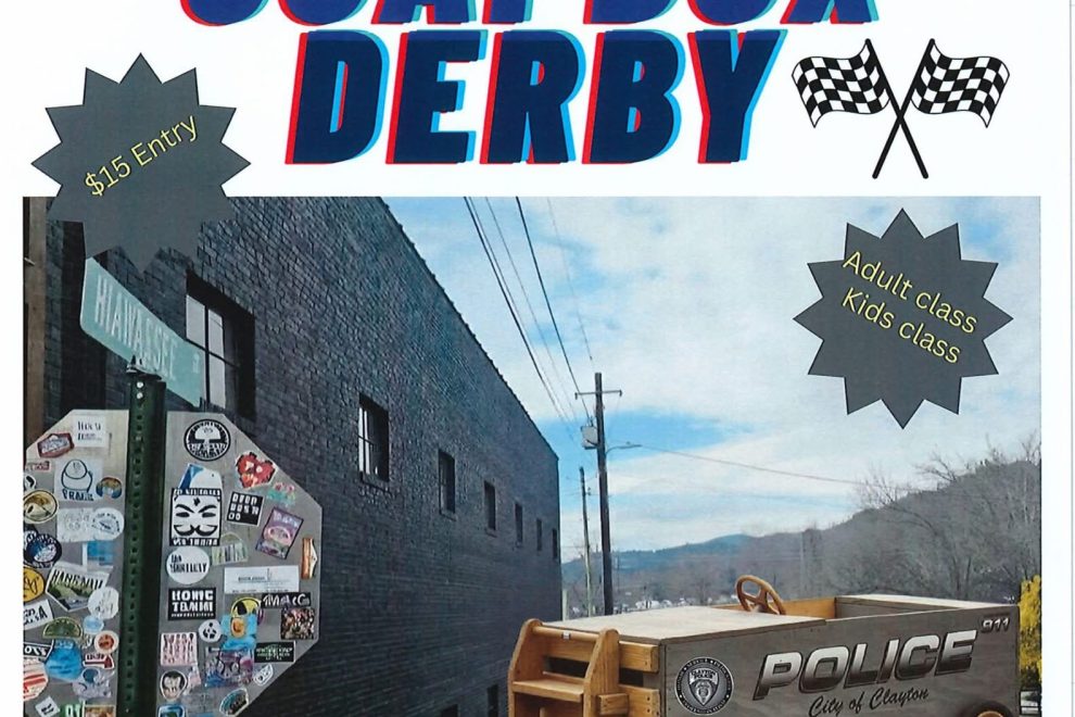 Poster advertising Clayton Police Dept's 1st Annual Auggie Soapbox Derby with bold red‑blue text and a police van image; event details at bottom. - Clayton, GA