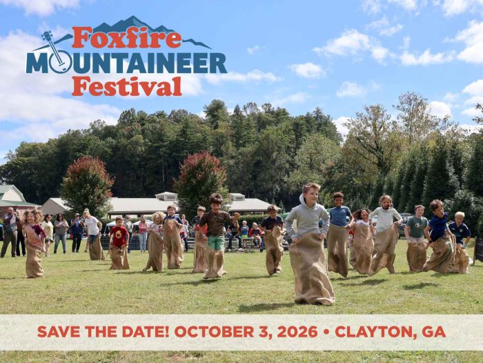 Foxfire Mountaineer Festival 2026 Promotional banner for Foxfire Mountaineer Festival with people in a sack race on a green field; date is October 3, 2026 in Clayton, GA.