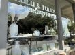 Storefront window display at Lulu & Lily Mercantile featuring blue-and-white ceramic vases and bowls arranged on a shelf inside.