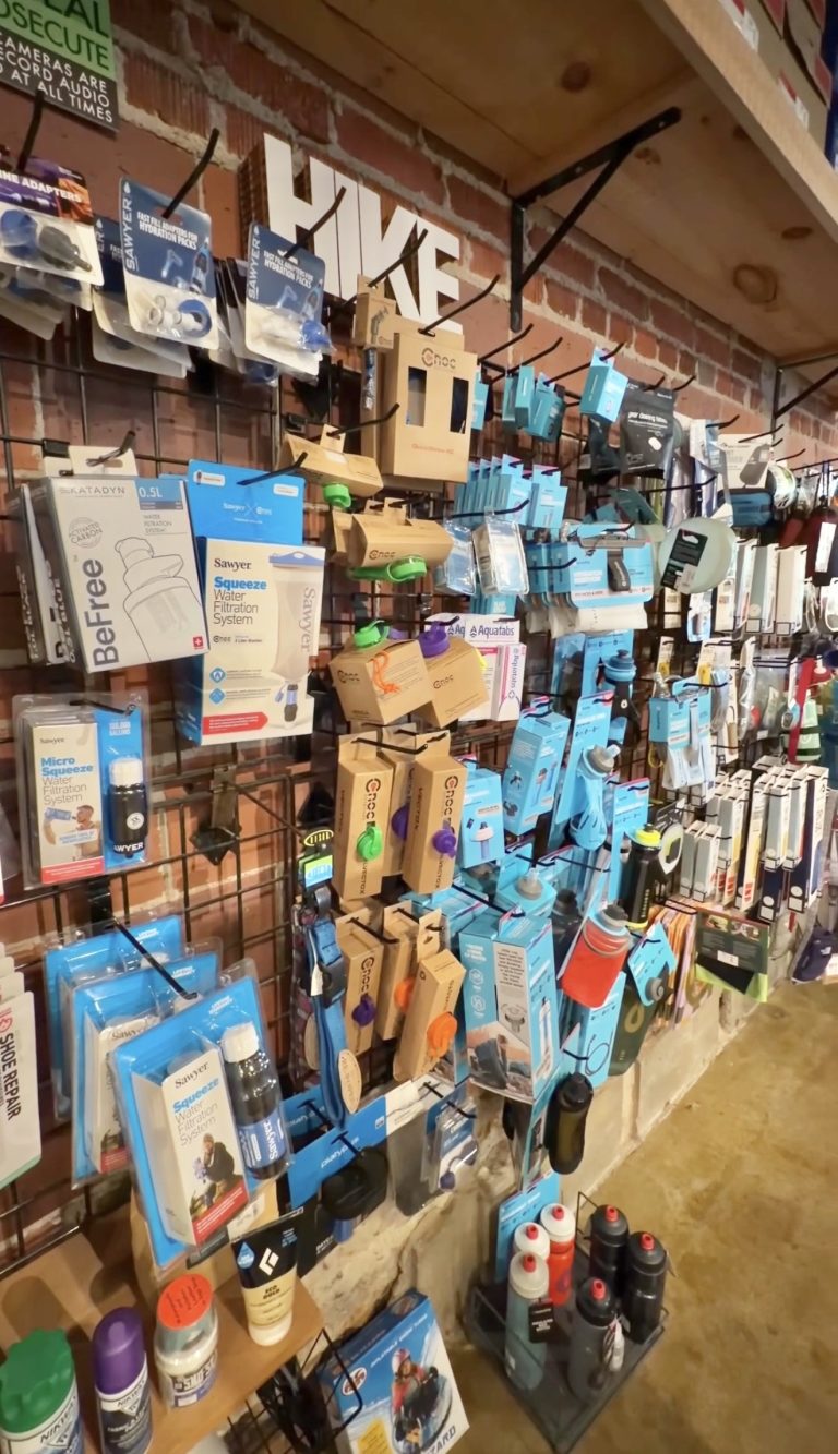 Packaged outdoor gear and accessories displayed inside Outdoor 76 in Clayton, Georgia